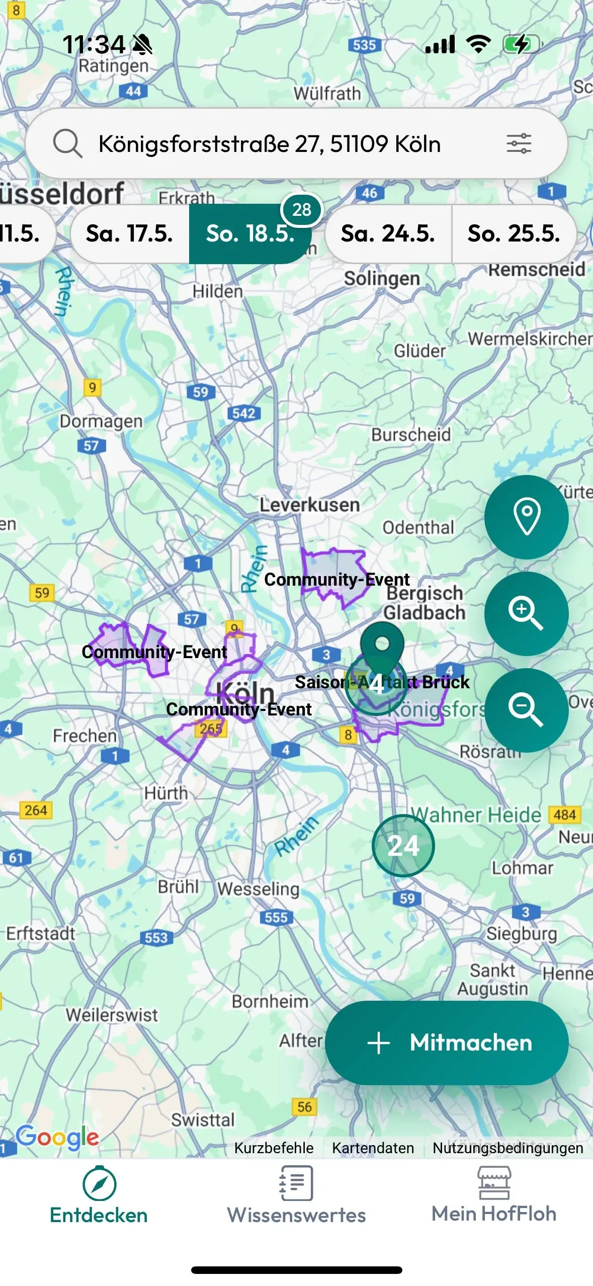 App-Screenshot: Karte rund um Köln mit violett markierten Bereichen „Community-Event“